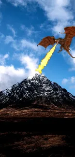 Dragon breathing fire over a snowy mountain under a bright blue sky.