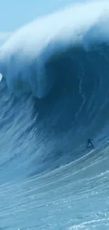 Massive ocean wave with surfer for mobile wallpaper.