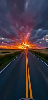 Vibrant sunset over an open road with dramatic clouds.