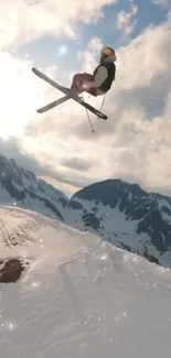 Skiing enthusiast performs jump with snowy mountains in background.