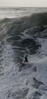 Surfer riding a massive ocean wave, perfect mobile wallpaper.