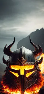 Viking helmet with fiery backdrop and mountains.