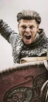 Fierce Viking warrior in armor, holding shield and shouting during battle.