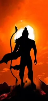 Silhouette of a warrior in front of a fiery orange sunset.