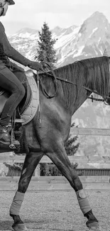 Monochrome wallpaper of a rider on horseback with mountain background.