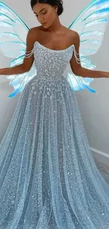 Woman in a sparkling blue gown with fairy wings.