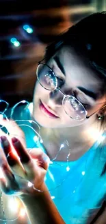 Woman with glasses holding glowing fairy lights.