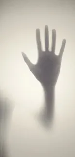 Ethereal silhouette of a hand on a light gray background.