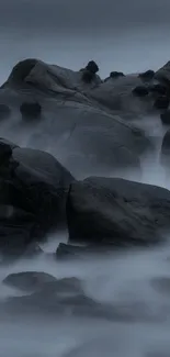 Misty rock formation in a serene ocean landscape.