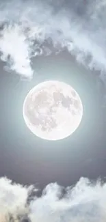 Full moon surrounded by clouds in a serene night sky.