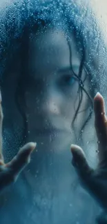 Silhouette of a woman against rain-covered glass