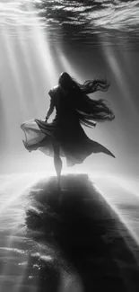 Ethereal silhouette underwater illuminated by artistic light beams.