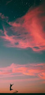 Silhouette dancing against twilight sky with pink clouds and stars.