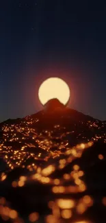 Sunset over mountains with glowing lights and dark sky.