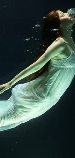 Woman in white dress floating underwater.