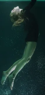 Graceful underwater woman in dark green setting.