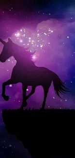 Silhouette of a unicorn against a colorful galaxy night sky with stars.