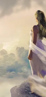 Ethereal woman in flowing dress on a mountain edge with cloudy sky.