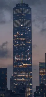 Luminous skyscraper against a dark city skyline in the evening.