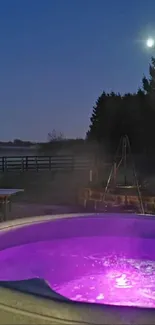 Outdoor hot tub with glowing purple water at night.