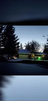 Twilight view of a house with trees and green lights.