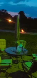 Nighttime patio scene with chairs and table under a dimly lit sky.