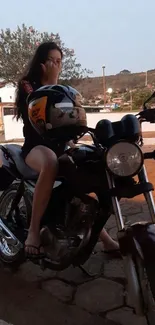 Woman with motorcycle during evening.