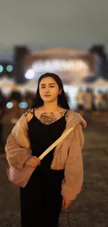 Stylish person walking in evening light with a city backdrop.