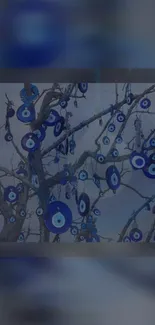 Blue evil eye amulets hanging on tree branches in a mystical design.