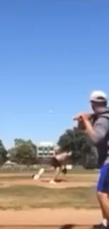 Baseball player ready to bat under a clear blue sky.