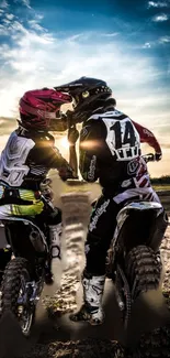 Two motocross riders at sunset with dirt bikes, capturing an adventurous moment.