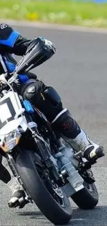 Motorcycle racer on track with sharp cornering.