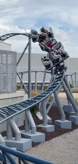 Exciting blue roller coaster ride with sky backdrop.