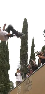 Skater performing high-flying trick surrounded by photographers.