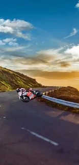 Racer leans into turn on a scenic road at sunset.