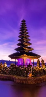 Asian pagoda at sunset with a vibrant purple sky, reflecting on the water.