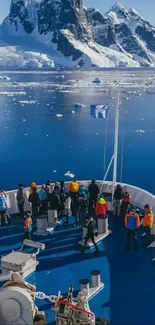 Adventure travelers exploring icy Antarctic waters with mountainous backdrop.