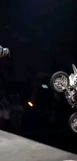 High-flying motocross bike leaving the ramp in dynamic action at night.