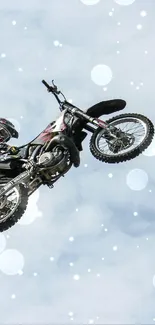 Motocross rider performs a freestyle stunt high in the sky.