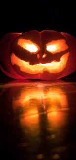 Glowing carved pumpkin in the dark