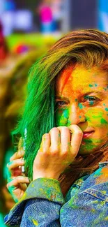 Woman with colorful powder on face, vibrant festival vibe.