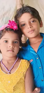 Brightly dressed children smiling joyfully.