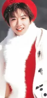 Joyful child in red hat and white coat in a winter setting.