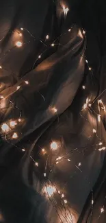 Dark fairy lights illuminating soft fabric background.