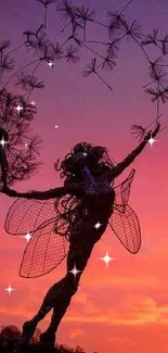 Fairy sculpture silhouette at sunset with a vibrant sky.