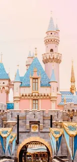 Fairytale castle with pastel pink sky and blue turrets.