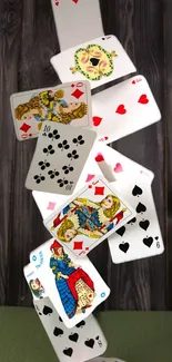 Falling playing cards on a wooden background.