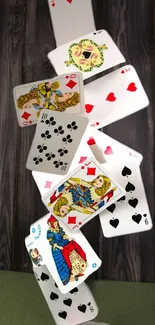 Falling playing cards in motion against a wooden background.