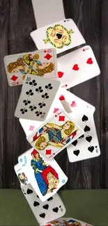 Falling playing cards with vibrant designs.