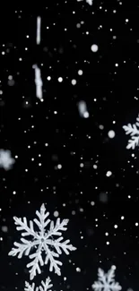 Snowflakes gently falling on a dark background.
